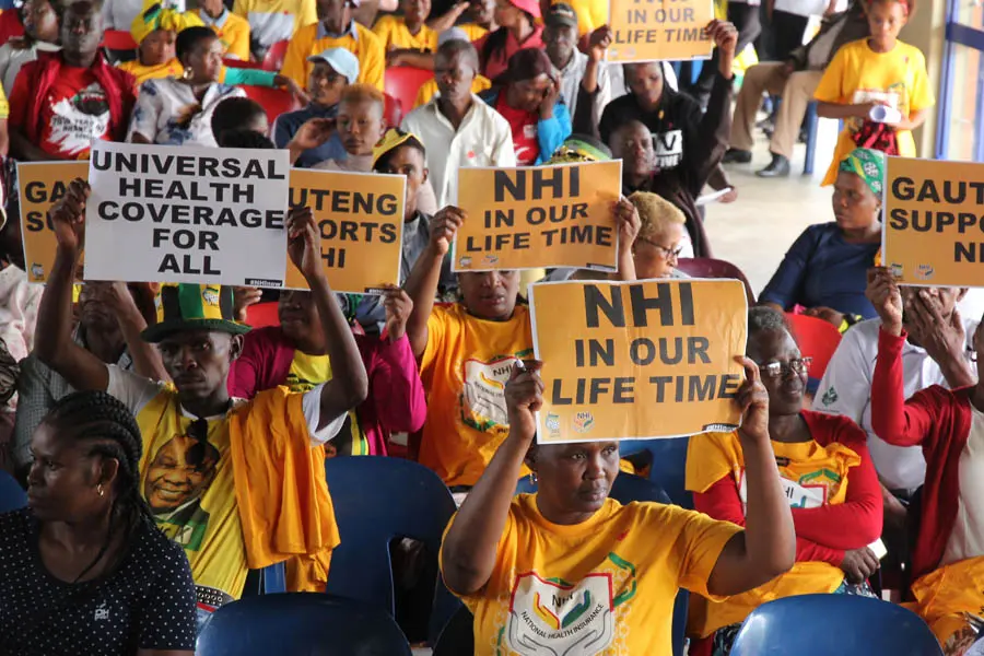group holding posters - NHI in our lifetime
